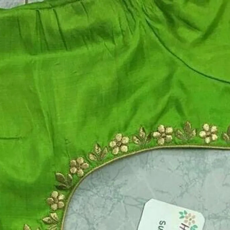 Green blouse back with delicate gold floral embroidery along neckline