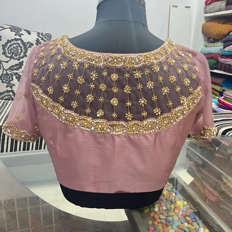 Mauve blouse with sheer net yoke and gold beadwork on mannequin