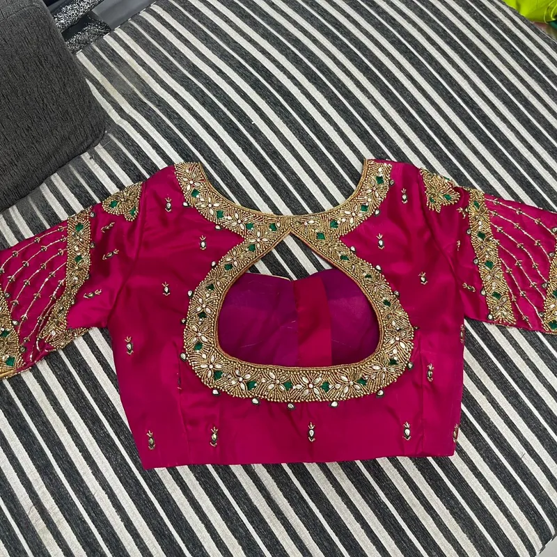 Pink bridal blouse with heavy gold and mirror embroidery back design