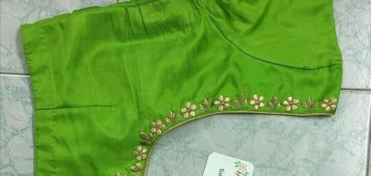 Green blouse back with delicate gold floral embroidery along neckline