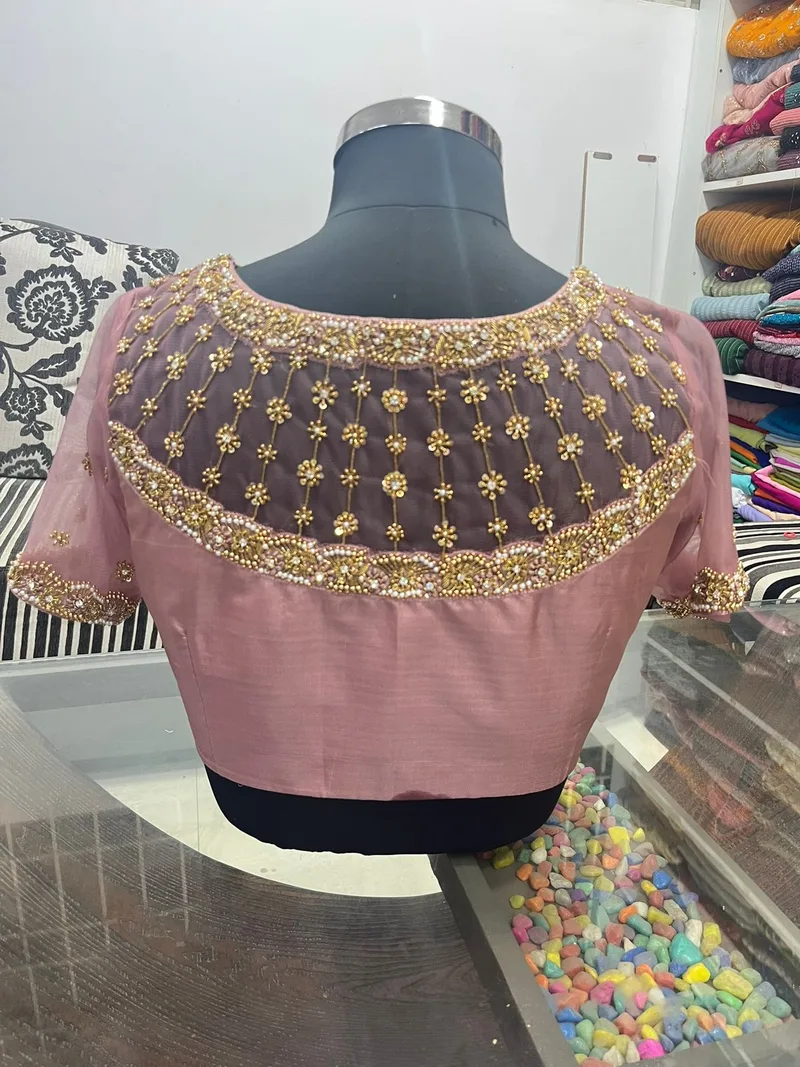 Mauve blouse with sheer net yoke and gold beadwork on mannequin