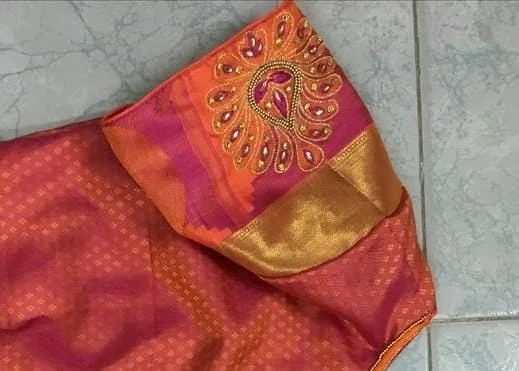 Peach fabric with red and green embroidery motif — pre-stitching layout