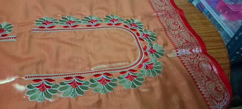 Peach fabric neckline with red-green leaf embroidery border