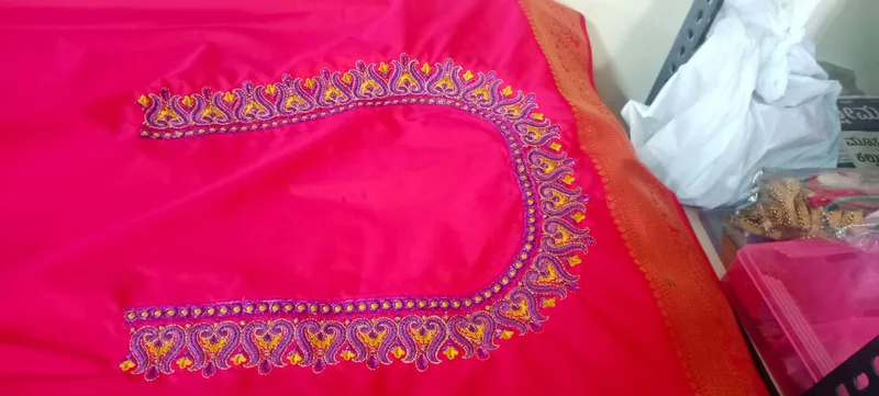 Pink fabric with colourful heart-shaped neckline embroidery