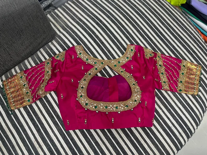 Pink bridal blouse with heavy gold and mirror embroidery back design