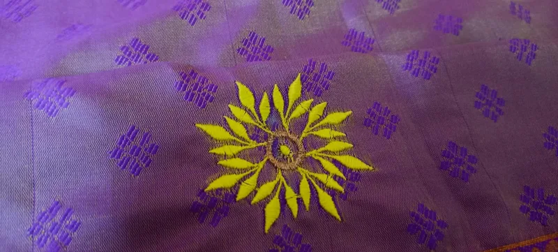 Purple silk fabric with gold sun motif embroidery detail