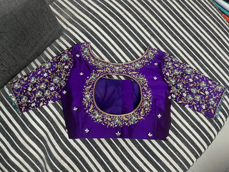 Purple blouse with circular cut-out back and heavy floral embroidery