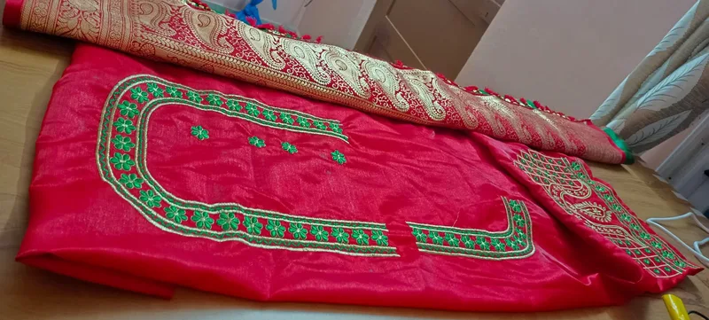 Red fabric wide view showing complete green embroidery design