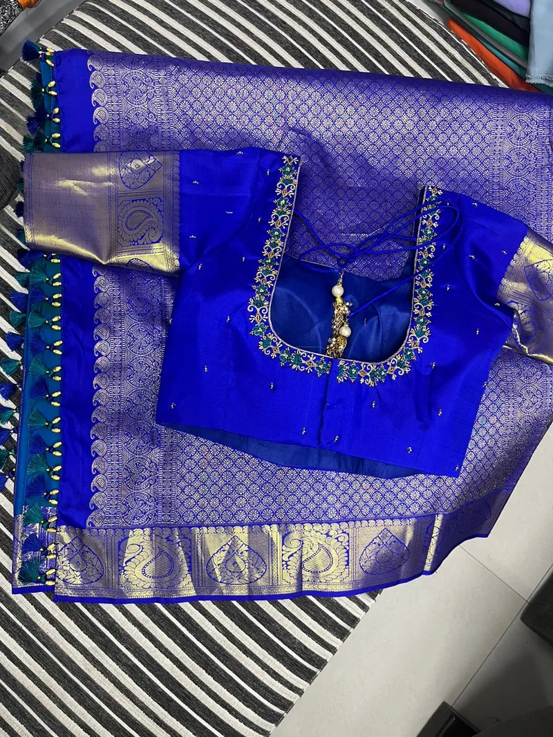 Royal blue hand embroidery blouse paired with a blue Banarasi saree