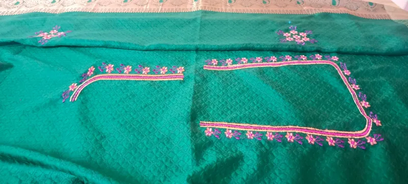 Teal fabric wide view showing complete floral embroidery layout