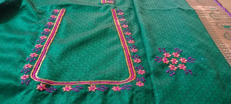Teal green fabric with pink floral embroidery neckline design